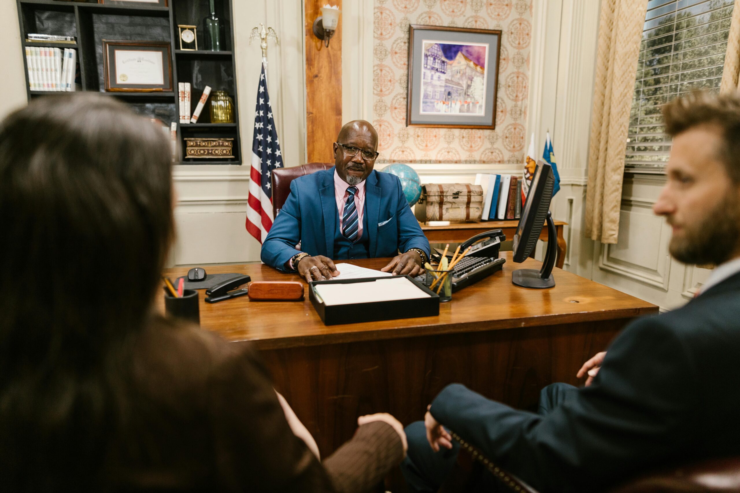 Legal Practice Area A professional lawyer meeting with clients in his office at a legal consultation.