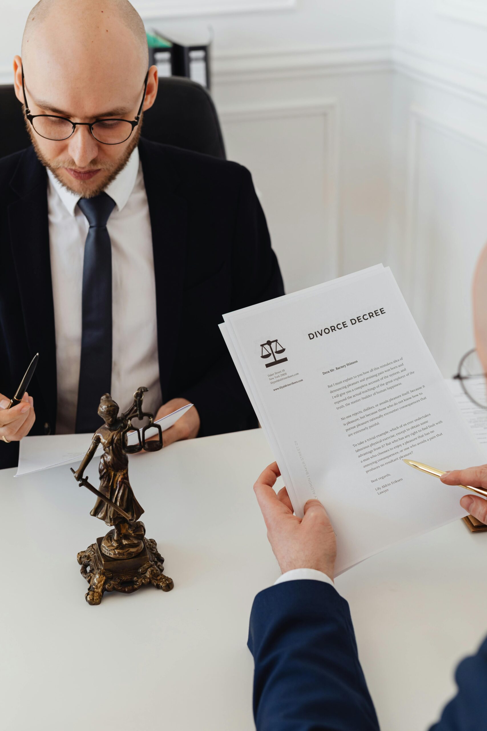 Contract Drafting Review and Para Legal Two lawyers discussing divorce decree documents in a professional office setting.